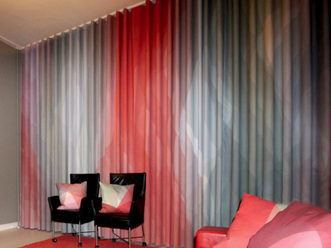 Curtain and Cushions in Red, Deep Red, and Grey-Blue to Match the Interior